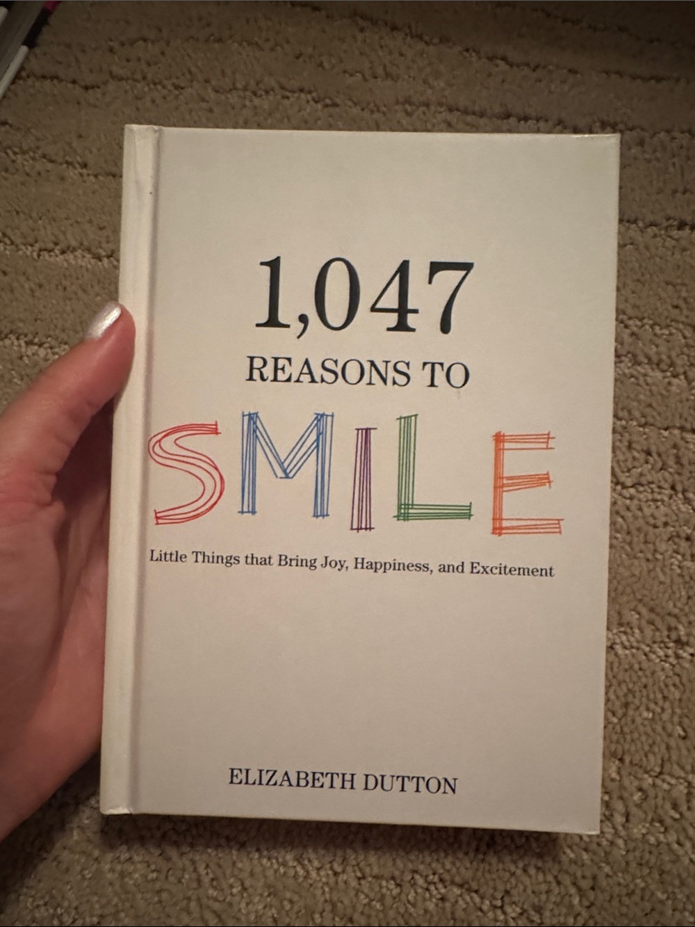 Urban Outfitters White “1,047 Reasons to Smile” Coffee Table Book